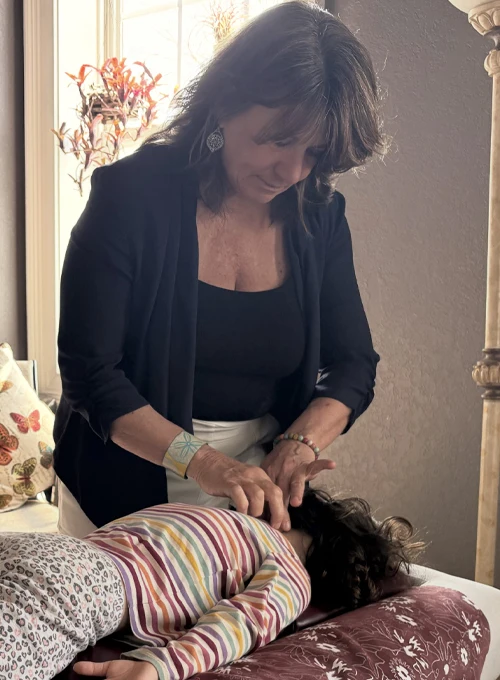 Deana Brooksher Adjusting a Child